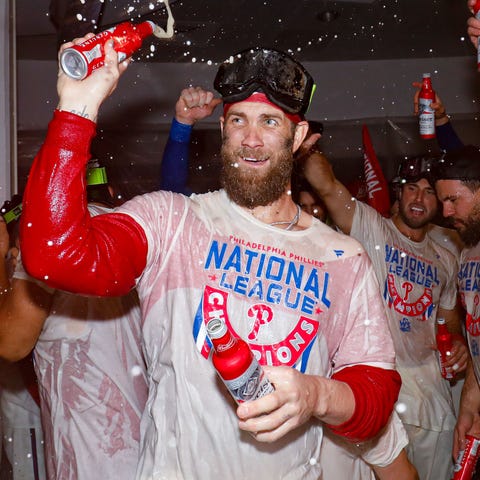 Bryce Harper celebrates in the clubhouse after the