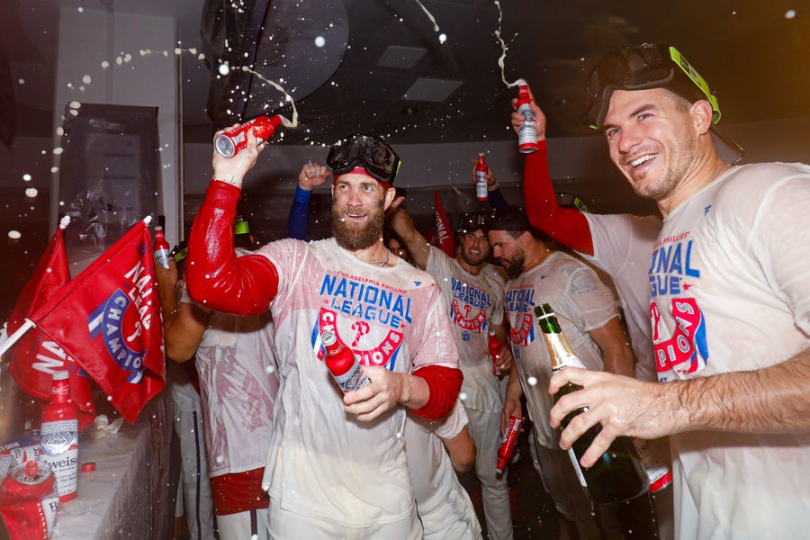 Bryce Harper celebrates in the clubhouse after the Phillies' Game 5 win.