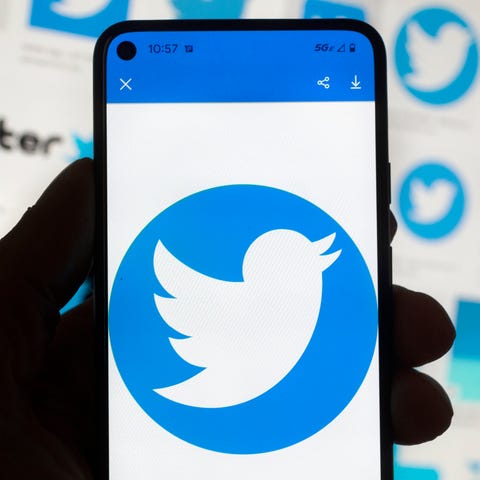 The Twitter logo is seen on a mobile phone.