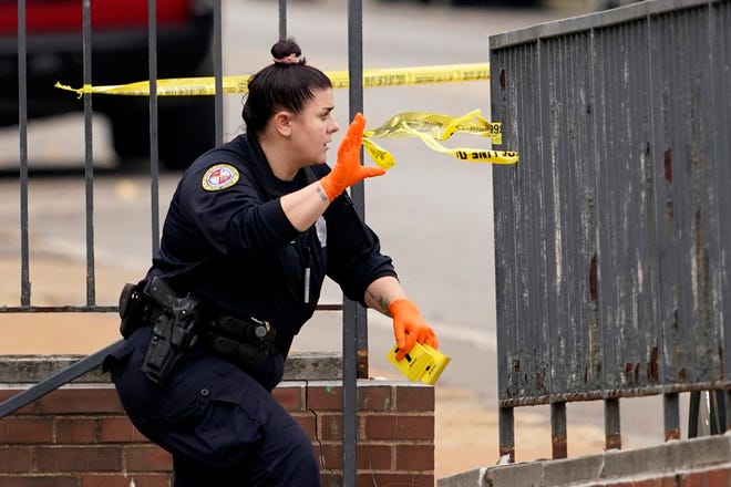 A member of the St. Louis Police Department investigates the scene of a shooting at Central Visual and Performing Arts High School Monday, Oct. 24, 2022, in St. Louis.