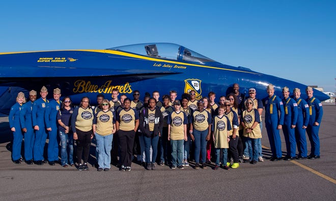 Posing with the cadets from Jefferson County High and Middle schools are Blue Angel Pilots (from left) Lt. Katlin Forster, LCDR Julius Bratton, Maj. Frank Zastoupil, LCDR Chris Kapuschansky, Capt. Brian Kesselring, Lt. Scott Goossens, LCDR Cary Rickoff and LCDR Griffin Stangel.