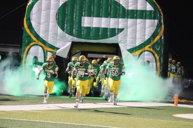 The Green Machine team, including No. 9 Will Taylor; No. 17 Jordan Weinzierl, and No. 58 Russell Brown take the field on Friday, Oct. 21.