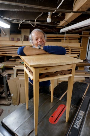 Channing Gray works on a maple and walnut table in his Providence workshop in 2019.