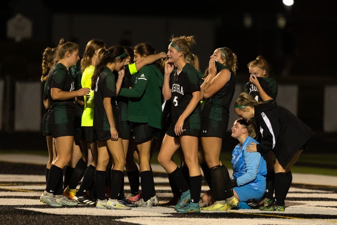 The Aurora Greenmen come together in the end zone after falling to the Chagrin Tigers 1-0 during a division II district semifinal playoff soccer match Monday, October 23, 2022 at Aurora High School.