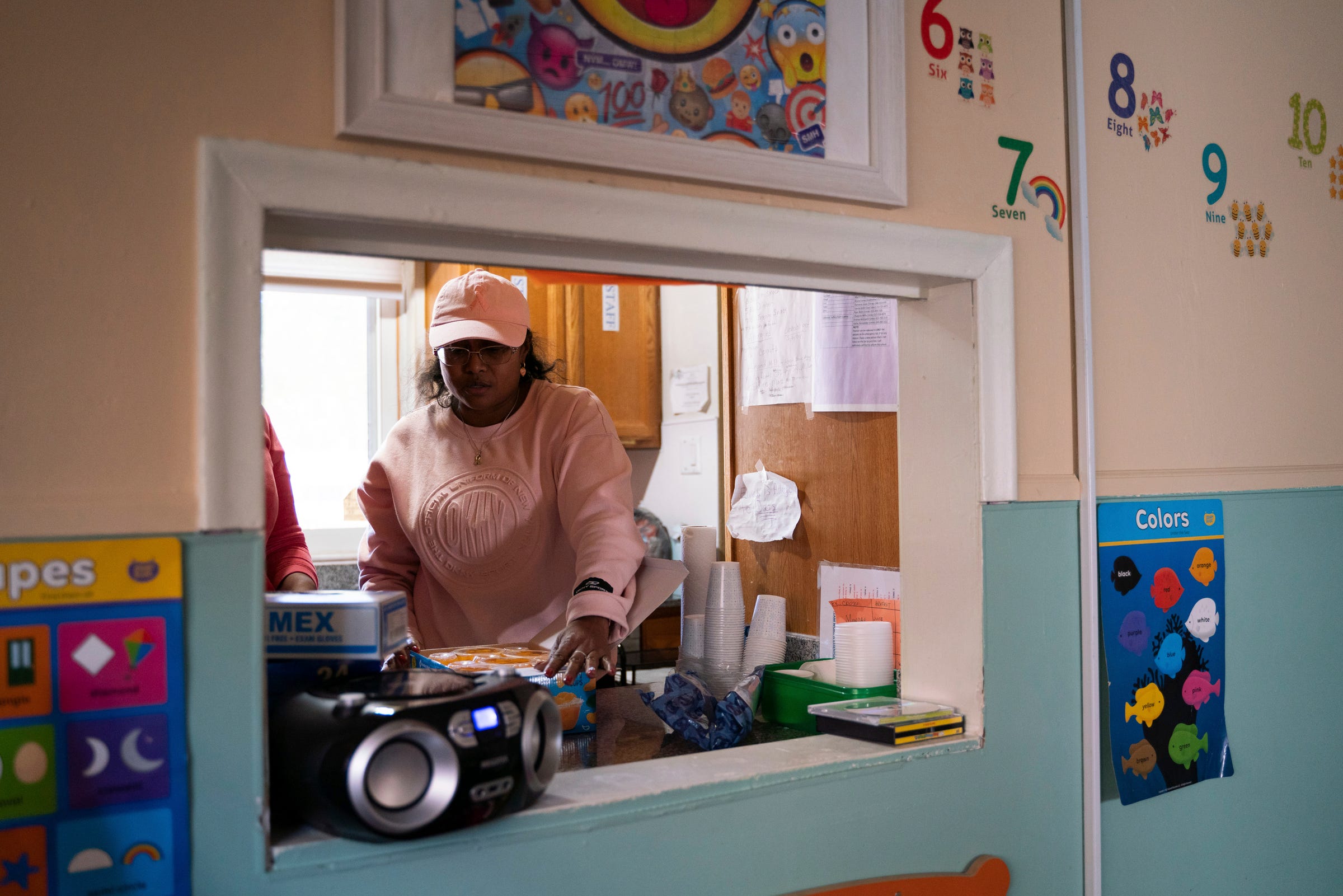 Day care owner Betty Henderson, 51, helps an employee plan for lunchtime at Angels of Essence Child Care Centre in Detroit on Friday, Oct. 21, 2022.