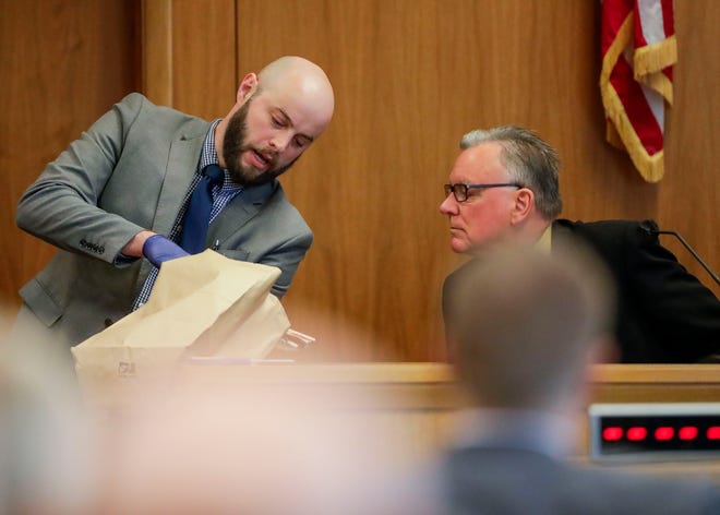 Wisconsin Assistant Attorney General Nathaniel Adamson presents an exhibit to former Wood County Lt. Robert Levendoske during his testimony on Tuesday, at the Wood County Courthouse in Wisconsin Rapids. John Sarver stands accused of the 1984 murder of Eleanore Roberts.