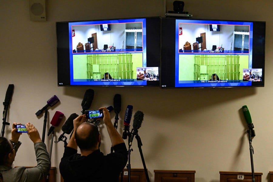 US basketball player Brittney Griner, who was sentenced to nine years in a Russian penal colony in August for drug smuggling, is seen on screens via a video link from a remand prison before a court hearing to consider an appeal against her sentence, at the Moscow regional court on October 25, 2022.