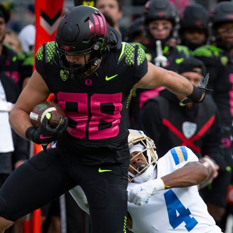 Oregon tight end Patrick Herbert takes off after c