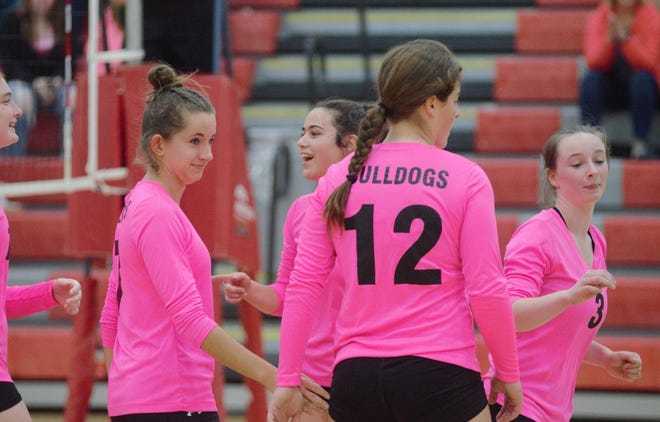 Inland Lakes volleyball players celebrate a point during a tri-meet at Johannesburg-Lewiston on Tuesday.
