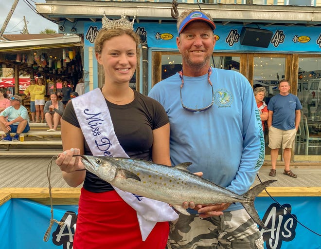 Kermit Miller of Valparaiso pulled in this 4.4-pound Spanish mackerel while fishing off the Okaloosa Island Pier. His catch is in first place in the Pier, Bridge, Jetty, Surf Division of the Destin Fishing Rodeo for Spanish. Also pictured is Miss Destin Ella Kathryn Campbell.