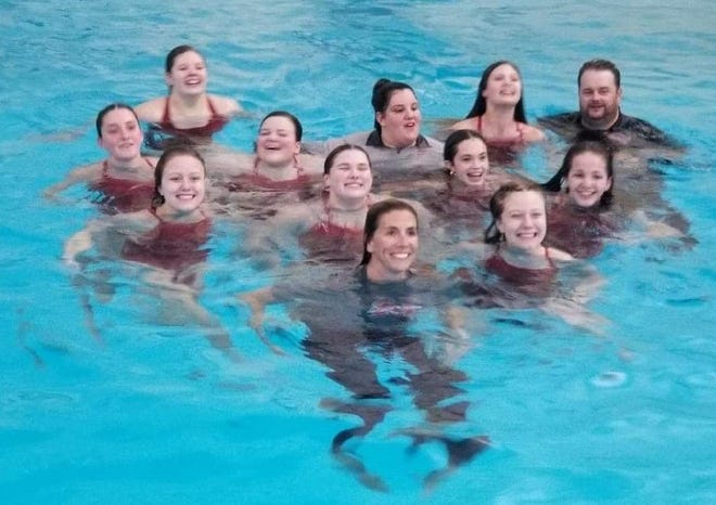 The Monroe swimmers and coaches were all in the water at Monroe High School following wins over Erie Mason-Ida and Ypsilanti Tuesday.