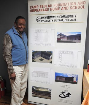 Peter Adigwe with artist conceptions and designs for the new Camp Beulah Foundation and Orphanage Home and School in Benin City, Nigeria. About $250,000 is needed to complete the project. Adigwe is speaking and raising money currently in the U.S.