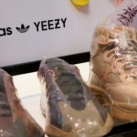 A sign advertises Yeezy shoes made by Adidas at Ki