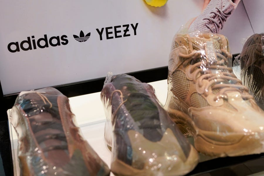 A sign advertises Yeezy shoes made by Adidas at Kickclusive, a sneaker resale store, in Paramus, N.J., Tuesday, Oct. 25, 2022. Adidas has ended its partnership with the rapper formerly known as Kanye West over his offensive and antisemitic remarks, the latest company to cut ties with Ye and a decision that the German sportswear company said would hit its bottom line.