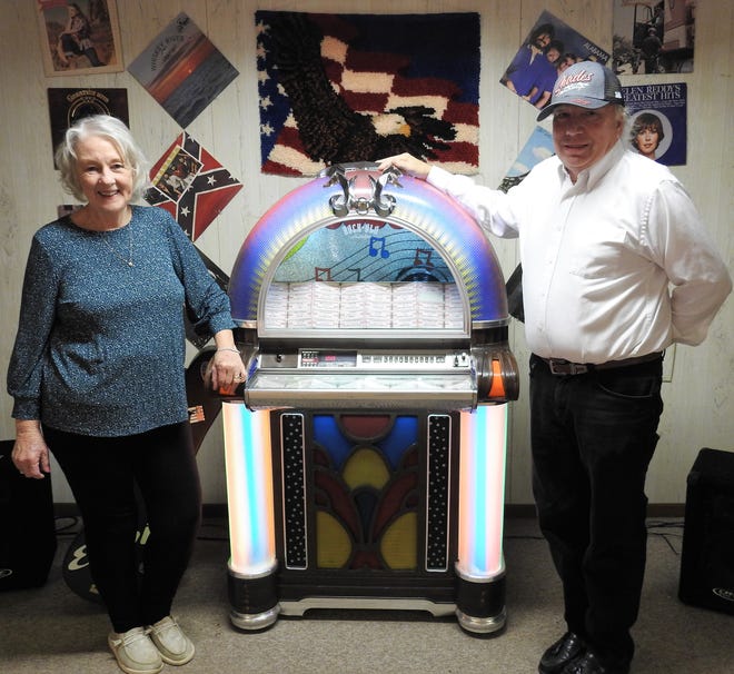 Sandi and Dave Miller with a jukebox from Pittsburgh, Pennsylvania, on the stage in the dance hall area of the new Orange Event Center. Dave said he wants to breathe life back into the unincorporated village of Orange by holding dances and having a space people can rent for parties, meetings and more.
