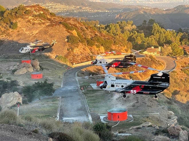 Firefighting helicopters from a fleet that serves Ventura, Orange and Los Angeles counties took part in a demonstration in the Topanga area Wednesday. Copter 61, at left, a Sikorsky, is stationed at the Camarillo Airport.