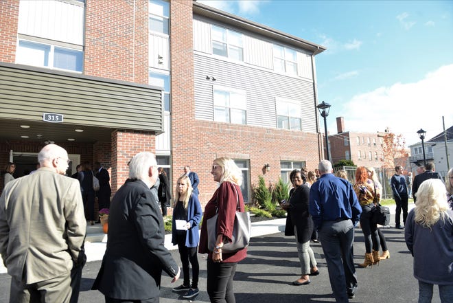 Area leaders and other people on hand for the ribbon cutting gather outside of Pearl House Zanesville on Thursday. State, county and city officials were among the people on hand, as Pearl House Zanesville held its official opening and ribbon cutting on Thursday in downtown Zanesville.