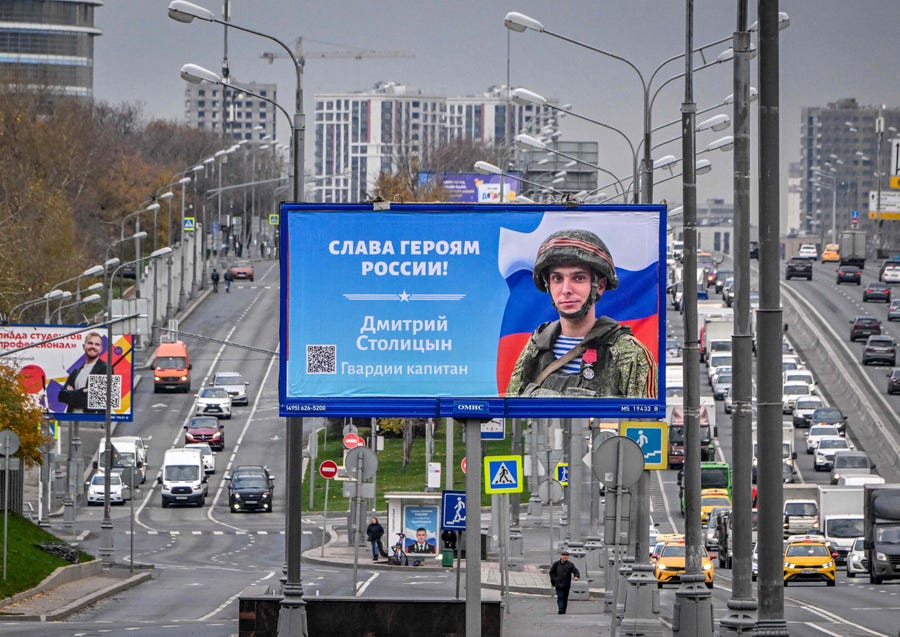 A photograph taken on October 24, 2022 shows a poster displaying a Russian soldier with a slogan reading 'Glory to the Heroes of Russia' decorating a street in Moscow on October 24, 2022.