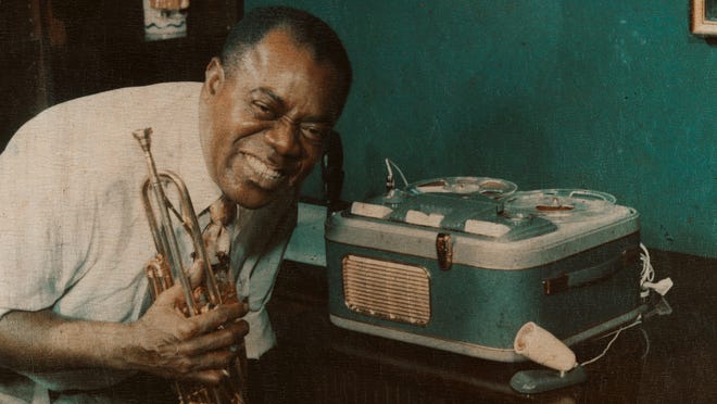 Louis Armstrong is pictured in front of one of many reel-to-reel tape machines that he used to record himself, as well as conversations with family and friends. They form the anchor of a new Armstrong documentary, "Black & Blues."