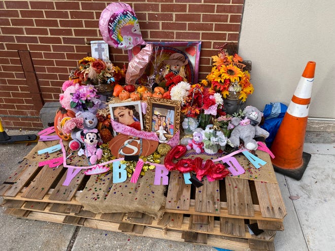A memorial for Toni Knight stands near the Perry Street entrance to the Petersburg ArtistSpace Lofts Friday, Oct. 28, 2022. Knight was 19 years old when she was caught in crossfire July 2, 2022 as she carried groceries into her apartment. Two of the three suspects in the case had their charges certified to a Petersburg grand jury Friday.