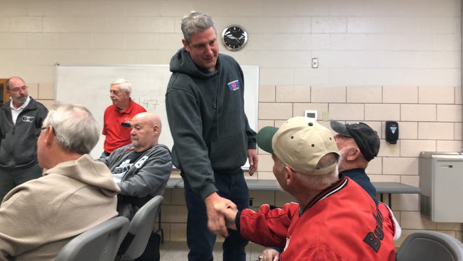 Tim Ryan, the Democratic candidate for Senate, shakes hands with an attendee at a meeting Friday with Hoover Co. union retirees.