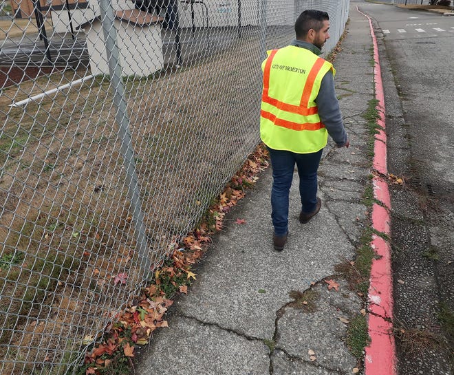 City of Bremerton project manager Nick Ataie walks along the old cracked sidewalk as he enters the View Ridge Elementary School property on Friday.