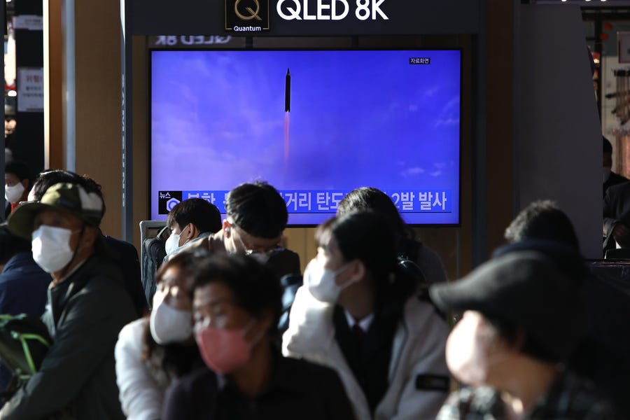 People watch a television broadcast showing a file image of a North Korean missile launch at the Seoul Railway Station on October 28, 2022 in Seoul, South Korea.