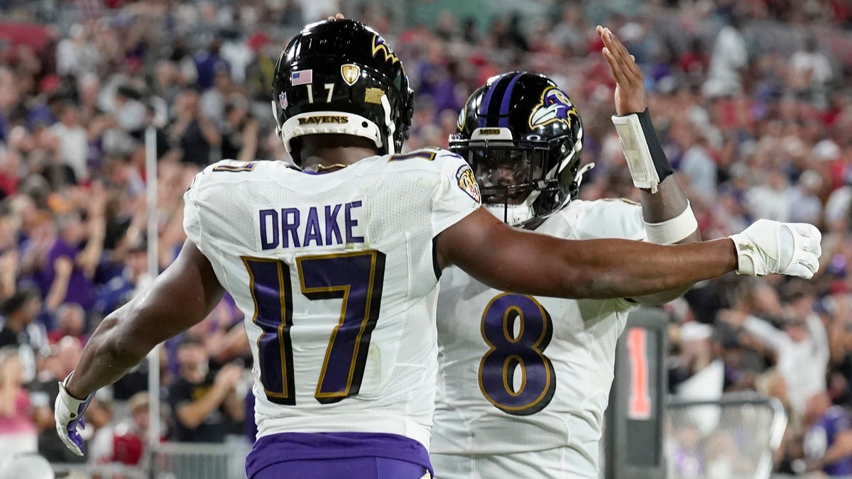 Baltimore Ravens running back Kenyan Drake (17) is congratulated by quarterback Lamar Jackson after scoring against the Tampa Bay Buccaneers.