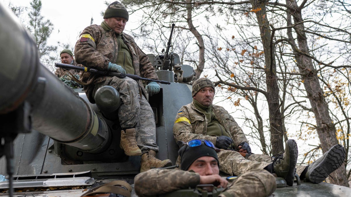 Ukrainian artillery unit members get prepared to fire towards Kherson on October 28, 2022, outside of Kherson region, amid Russia's military invasion on Ukraine.