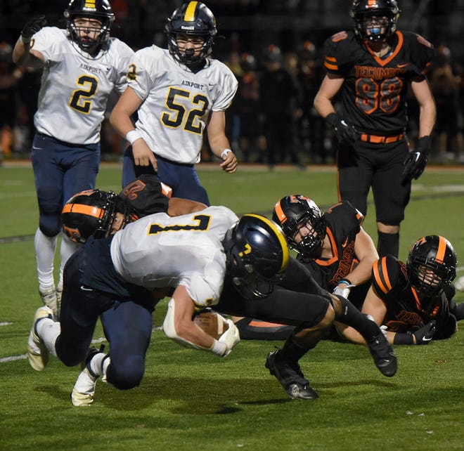 Jack Mills of Airport is stopped on fourth down by Draven Langston of Tecumseh near the end of the third quarter Friday night. Tecumseh won 52-28 in the opening round of the Division 4 state playoffs Friday night.