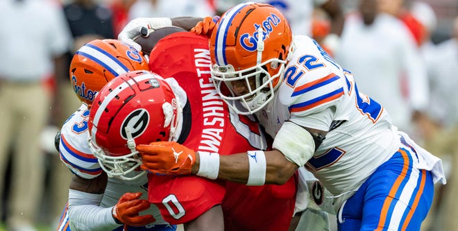 Georgia Bulldogs tight end Darnell Washington (0) gets stopped by Florida Gators safety Rashad Torrence II (22) as Florida takes on Georgia during first half action at TIAA Bank Field in Jacksonville, FL on Saturday, October 29, 2022. [Alan Youngblood/Gainesville Sun]
