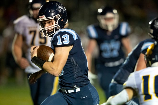 Bay Port's Cole Bensen (13) runs the ball against Wausau West in the third quarter of the Division 1 playoff football game Friday at Bay Port High School in Suamico.