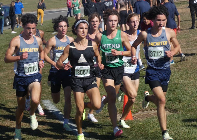 Lancaster seniors Trevor Lanoy, right, Kaiden Lanoy, back and Isaiah Lanoy, left, battle with the leaders during the Division I race of the regional championships at Pickerington North on Saturday, Oct. 29, 2022. The Golden Gales won the team championship.