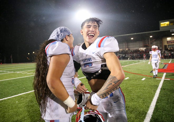 South Salem's Hatimu Letisi (50) and Zach Wusstig (3) hug after winning the Mayor’s Trophy game against North Salem on Oct. 28 at North Salem High School. The final score of the game was 33-14.