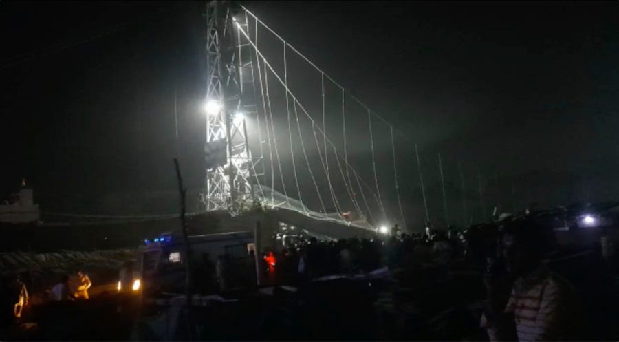 Rescuers work at night after a cable bridge across the Machchu river collapsed in Morbi district, western Gujarat state, India, Sunday, Oct. 30, 2022.