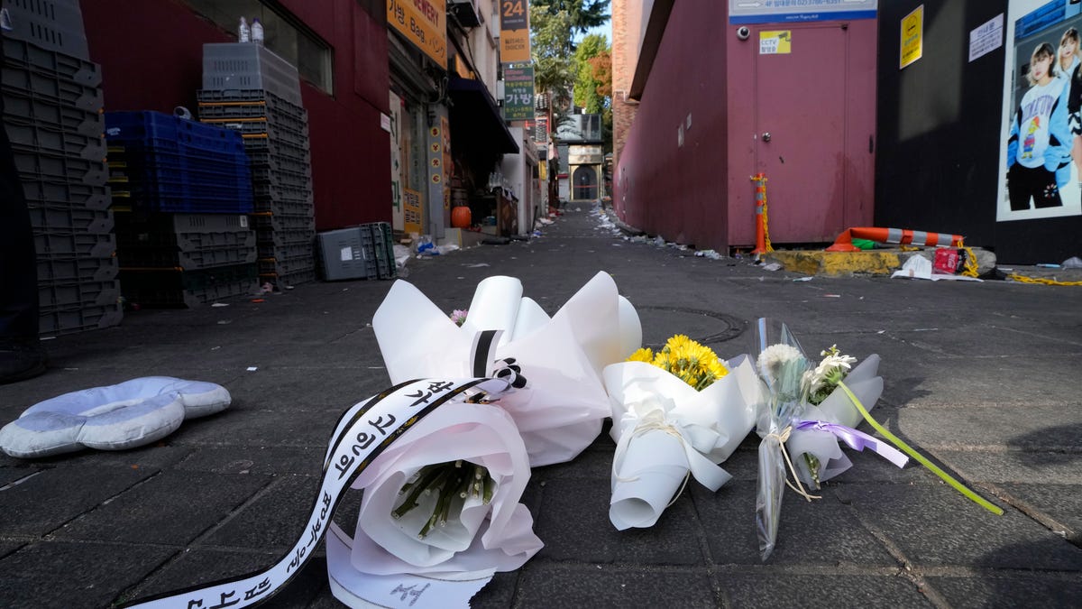 Flowers are seen at the scene of a deadly accident in Seoul, South Korea, Sunday, Oct. 30, 2022, following Saturday night's Halloween festivities.