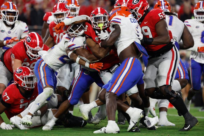 Oct 29, 2022; Jacksonville, Florida, USA; Georgia Bulldogs running back Kenny McIntosh (6) runs the ball in for a touchdown against the Florida Gators during the second half at TIAA Bank Field. Kim Klement-USA TODAY Sports