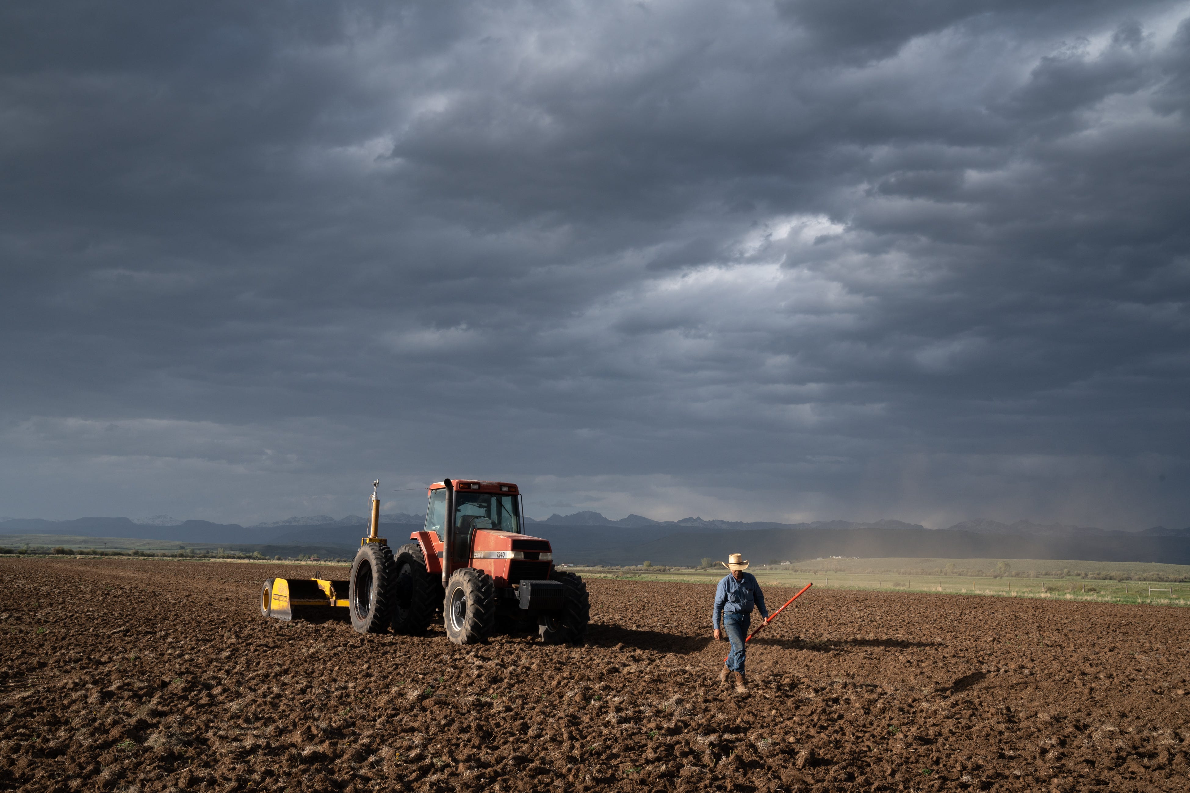 Tommy Johnston levels a field on Leslie Hagenstein's farm south of Pinedale, Wyoming, on  June 12, 2022. He works to ensure his flood irrigation is as efficient as possible because converting to other methods is too expensive. “I feel like I’m preparing myself as best I can without going into sprinklers.”