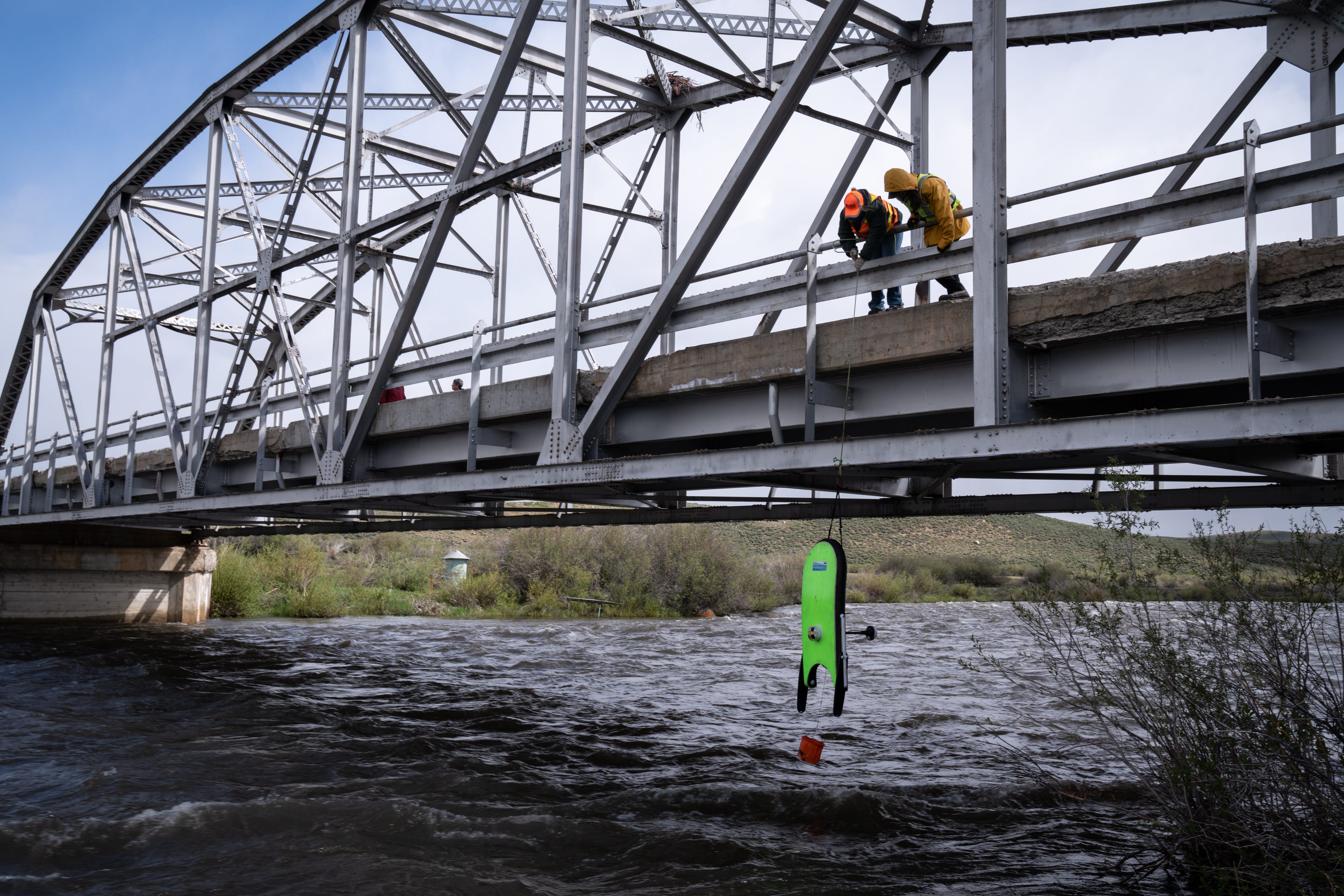 Megan Moss (left) and Shea Musselman, both with the United States Geological Survey, pull a hydroboard from the Green River on June 14, 2022. The hydroboard measures streamflow (discharge) and creates a streambed profile. Runoff at this point peaked relatively high compared to historic readings, but the season’s flow would end up well below average.