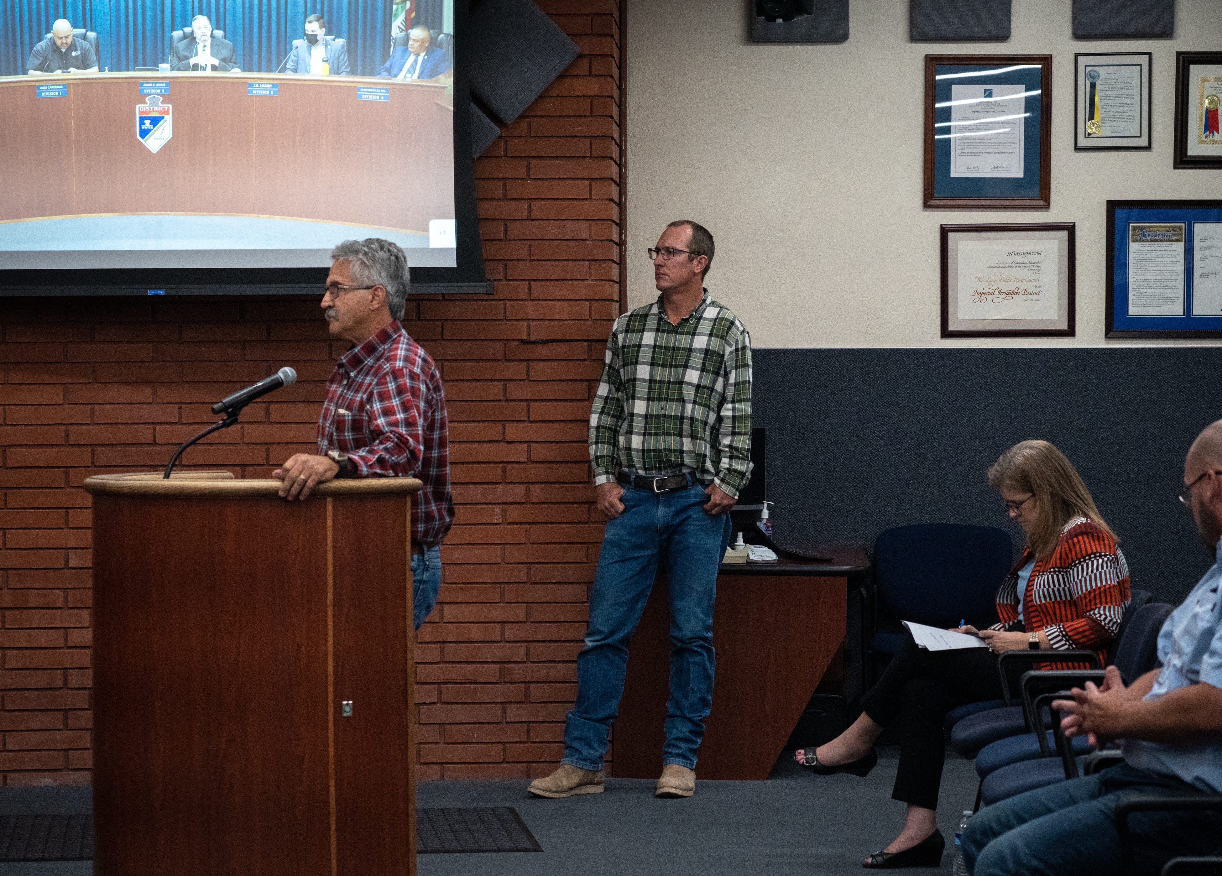 Tyler Sutter (center) waits to speak at an Imperial Irrigation District meeting on May 17, 2022, in William R. Condit Auditorium in El Centro, California. Sutter told officials he'd rather avoid rationing his water by having the district pay other farmers to conserve more.