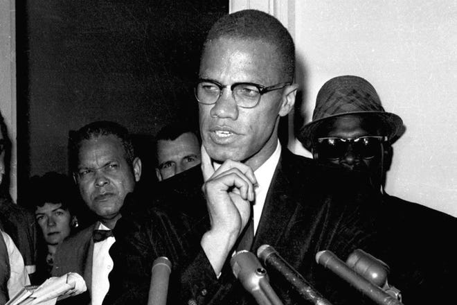 Malcolm X speaks to reporters in Washington on May 16, 1963. The city of New York is settling lawsuits filed on behalf of two men who were exonerated in 2021 for the 1965 assassination of Malcolm X, agreeing to pay $26 million for the wrongful convictions which led to both men spending decades behind bars, according to attorneys for the men Sunday, Oct. 30, 2022.