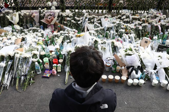 A person pays tribute to the victims of the Halloween celebration stampede in South Korea.