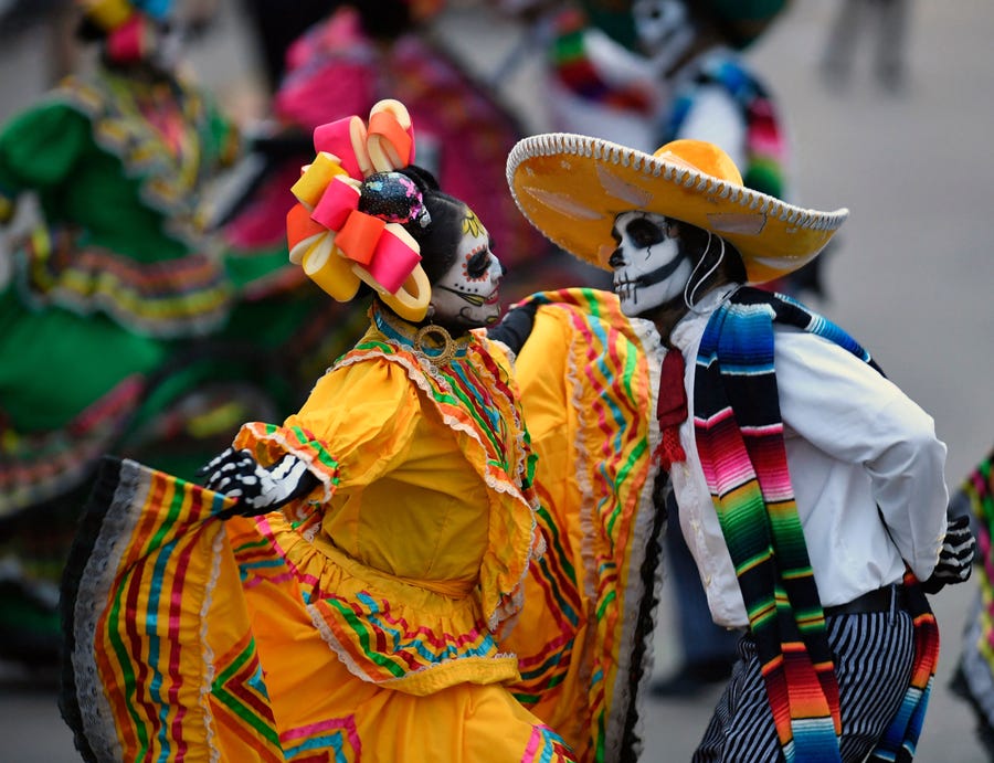 People take part in the "Day of the Dead Parade" in Mexico City on October 29, 2022.