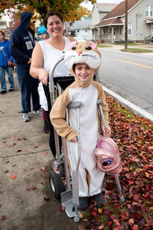 Karter Riggs, who recently tore her meniscus, gets a lift from a furniture dolly for trick or treating in Byesville. Visit daily-jeff.com for more photos.