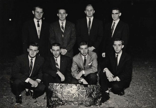 The Octopus inductees of 1957 pose by their rock. Clockwise from top left: DeWayne Sanburg, Don Gilles, Tom Ores, Walt Woods, Jerry Hatch, Chuck Hartmann, Bill Beabout and Ercel Davis.