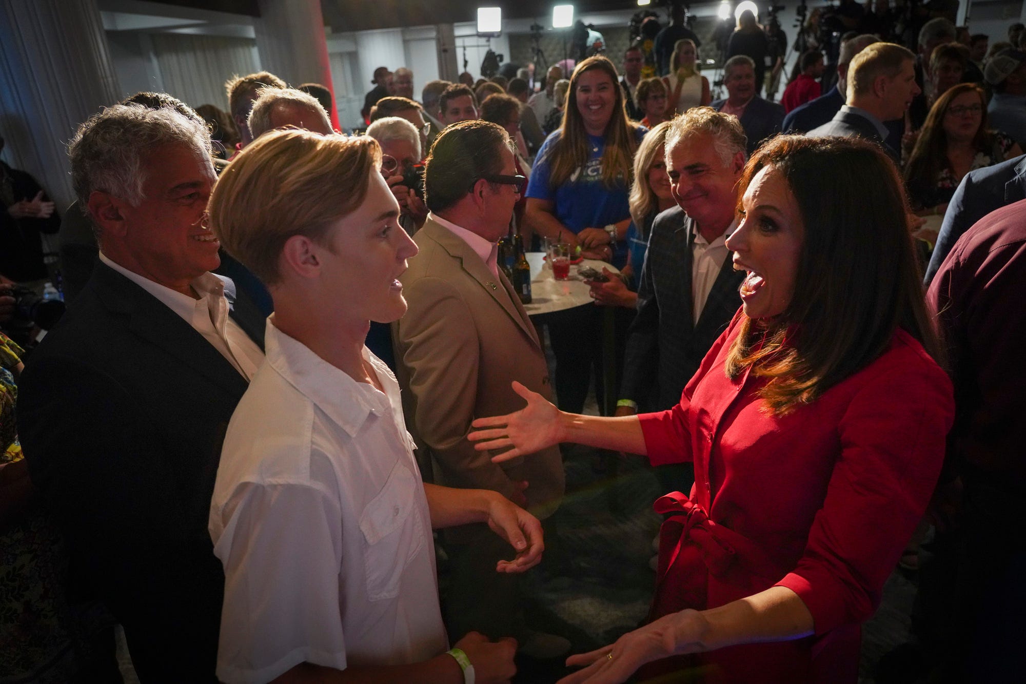 Tudor Dixon greets a young supporter just after winning the Republican primary race for governor at the Amway Grand Plaza in Grand Rapids on Aug. 2, 2022.
