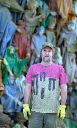 Scott Hocking poses in front of his installation, "The Secrets of Nature."