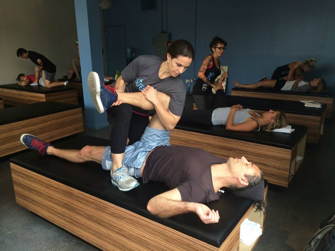 StretchLab is an assisted stretching center, where a trained practitioner stretches your body for you.