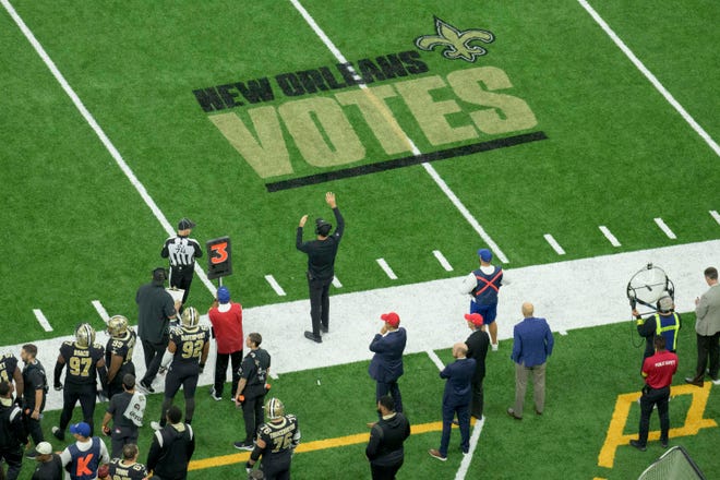 Voting reminders are seen on the field during an NFL football game between the New Orleans Saints and the Las Vegas Raiders in New Orleans, Sunday, Oct. 30, 2022.