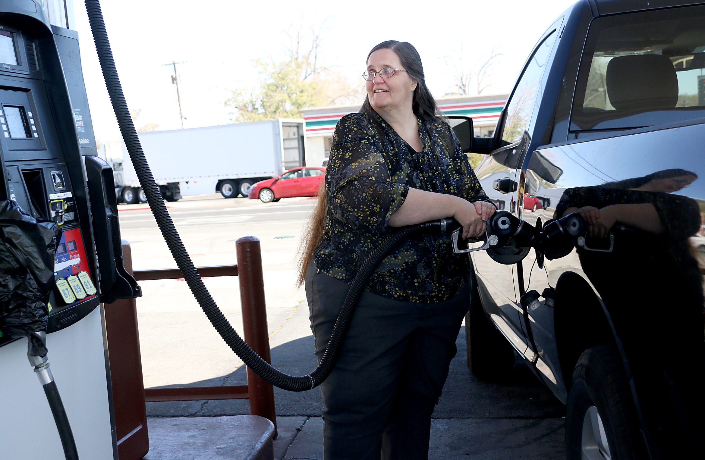 Joannah Schumacher stops to fill her tank with gas in Reno on Oct. 26, 2022.